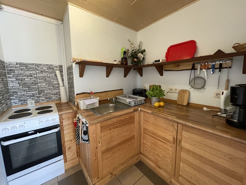 Countertop, Cabinetry, Property, Kitchen Appliance, Kitchen Stove, Kitchen, Gas Stove, Home Appliance, Wood, Interior Design