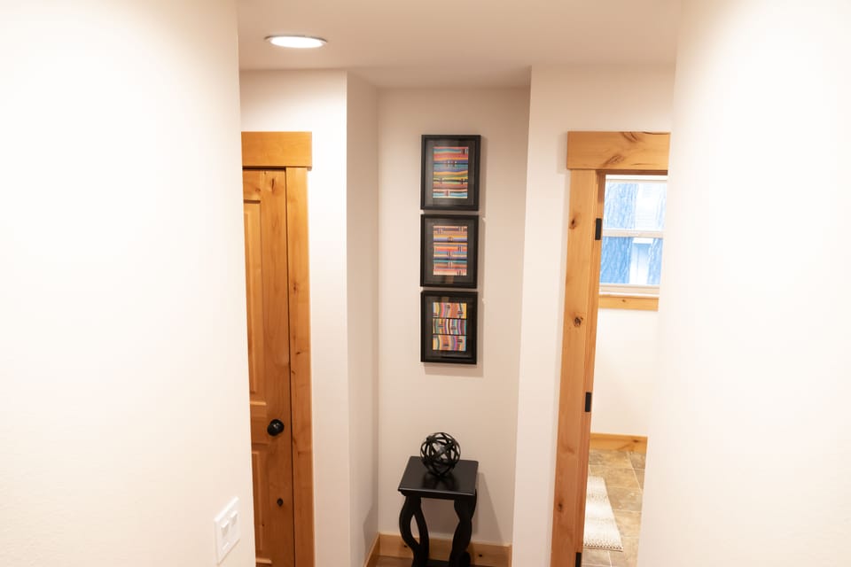 More art awaiting at bottom of stairs, adjacent to wine cellar!