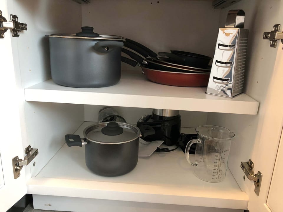 The kitchen comes complete with pots, pans, cups, etc.