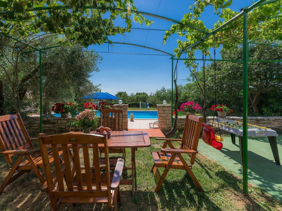 Plant, Furniture, Table, Sky, Chair, Botany, Outdoor Furniture, Shade, Outdoor Table, Building