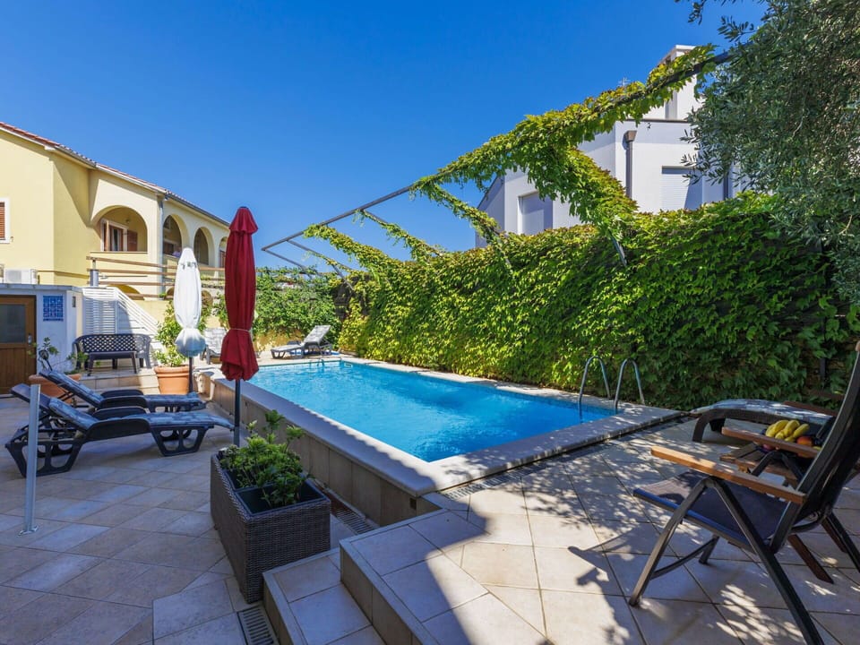 Sky, Plant, Swimming Pool, Outdoor Furniture, Shade, Water, Building, Grass, Wheel
