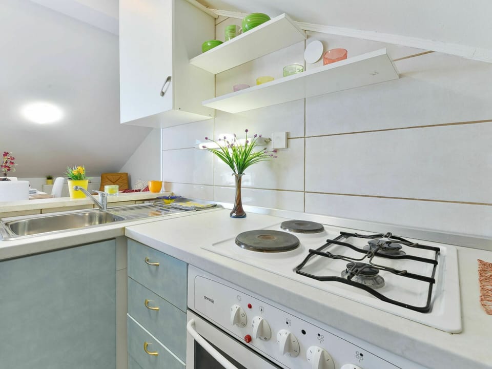 Countertop, White, Kitchen, Room, Property, Furniture, Tile, Interior Design, Cabinetry, Yellow