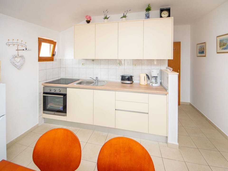 Countertop, Cabinetry, Furniture, Property, Sink, Kitchen, Wood, Orange, Kitchen Appliance, Flooring