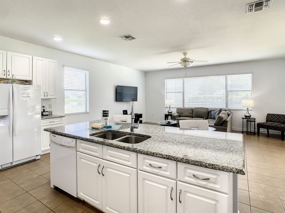Open-plan kitchen flowing into the living room, perfect for family gatherings.
