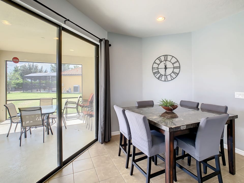 Elegant dining space with large sliding doors opening to the patio.
