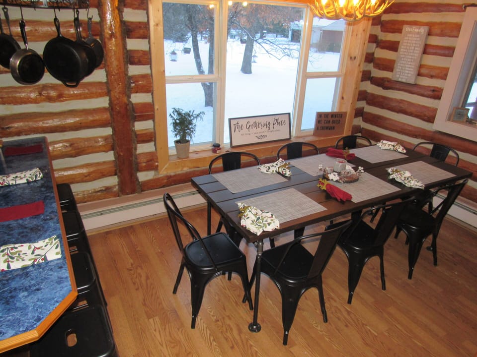view of table and island from stairway- Island has 4 bar stools.