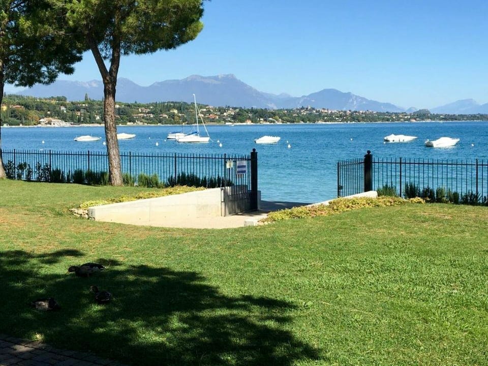 Water, Sky, Plant, Azure, Land Lot, Shade, Lake, Grass, Coastal And Oceanic Landforms, Natural Landscape