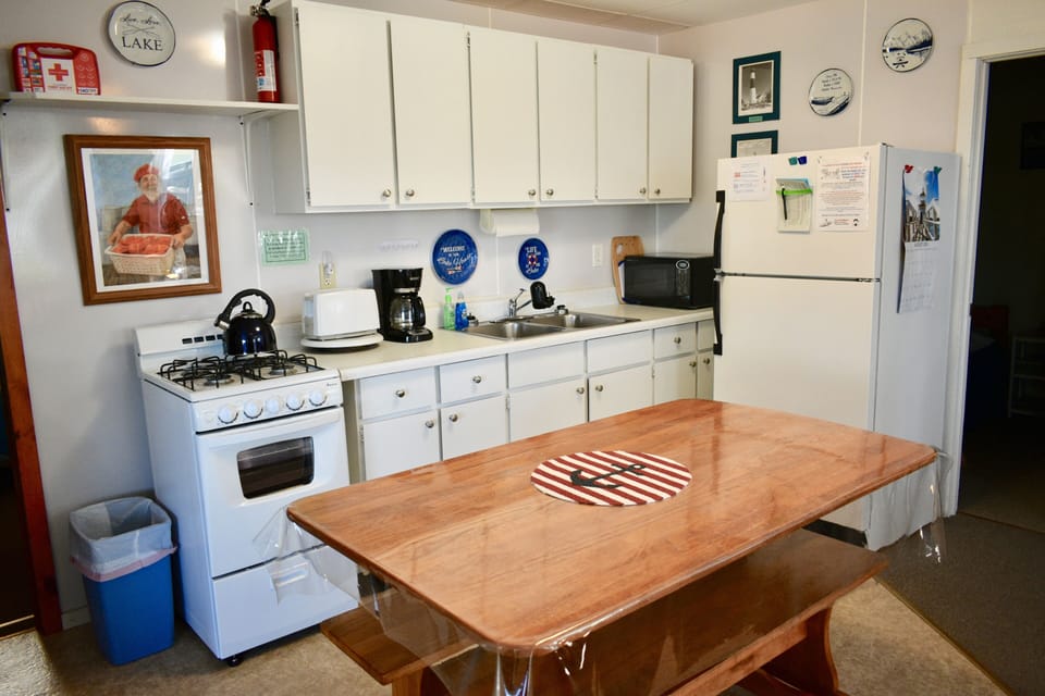 The full kitchen is supplied with dishes, utensils, pots & pans, & 2 dish towels