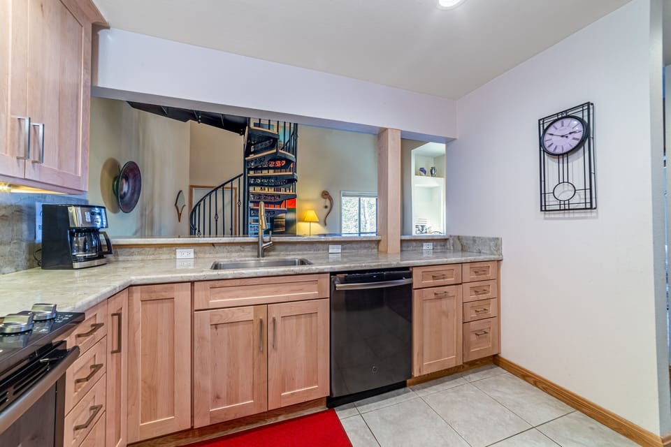 Kitchen open to living area with bar seating.