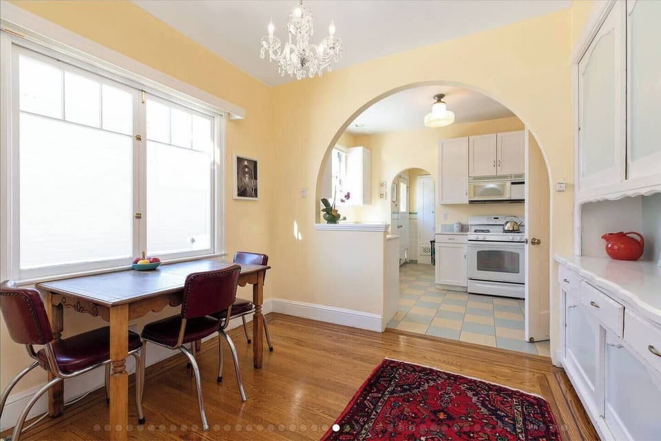 Alternate angle of breakfast room and kitchen, both with exterior views