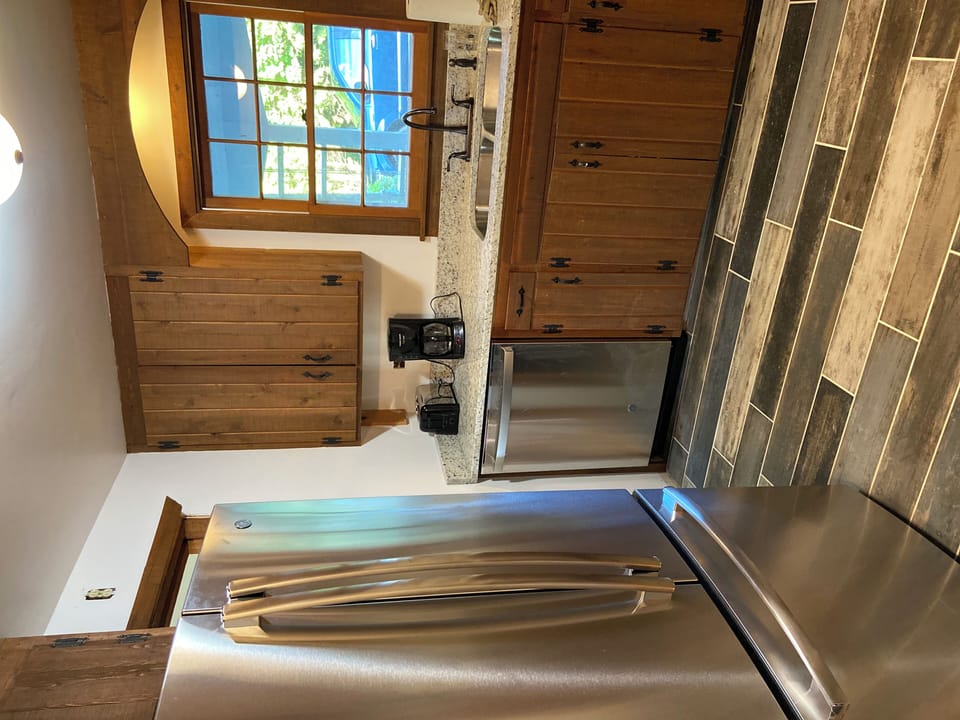 Kitchen w/ stainless appliances; kept cedar cabinets for Door County charm!