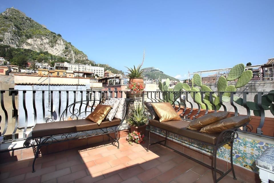 small roof terrace with view on Mt. Etna, the old town of Taormina and the Greek Theatre