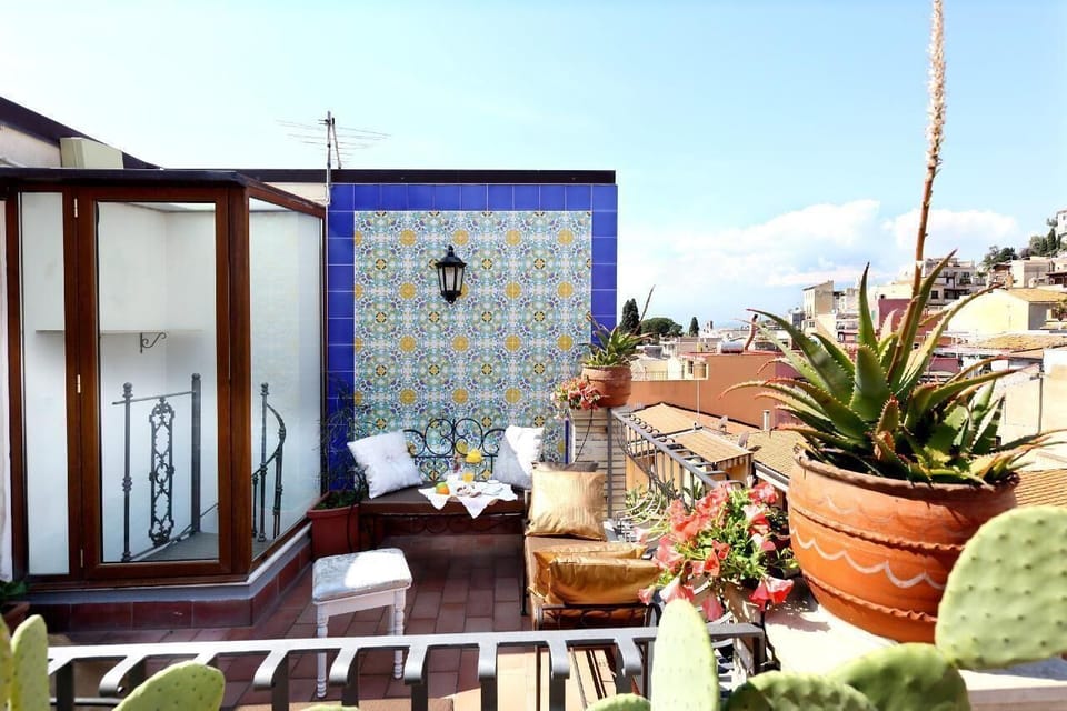 small roof terrace with view on Mt. Etna, the old town of Taormina and the Greek Theatre