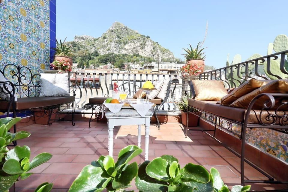 small roof terrace with view on Mt. Etna, the old town of Taormina and the Greek Theatre