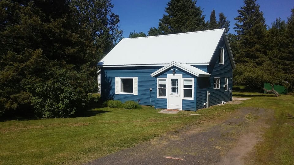 Front of the house with a driveways on the left and right side of the house. 
