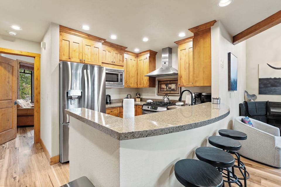 Full size kitchen with granite countertops new hardwood flooring and stainless steel appliances throughout.