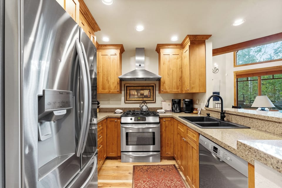 Full size kitchen with granite countertops new hardwood flooring and stainless steel appliances throughout.