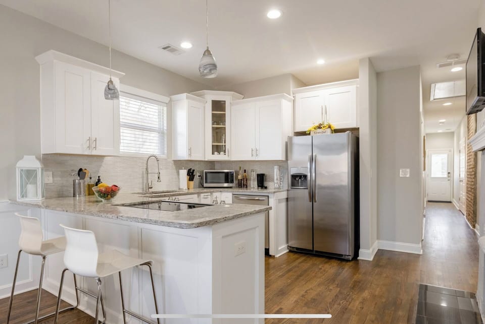 Fully equipped kitchen with ample counter space, microwave, and refrigerator