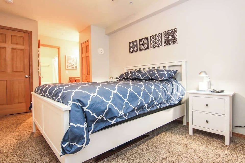 The bedroom houses a cozy king bed
