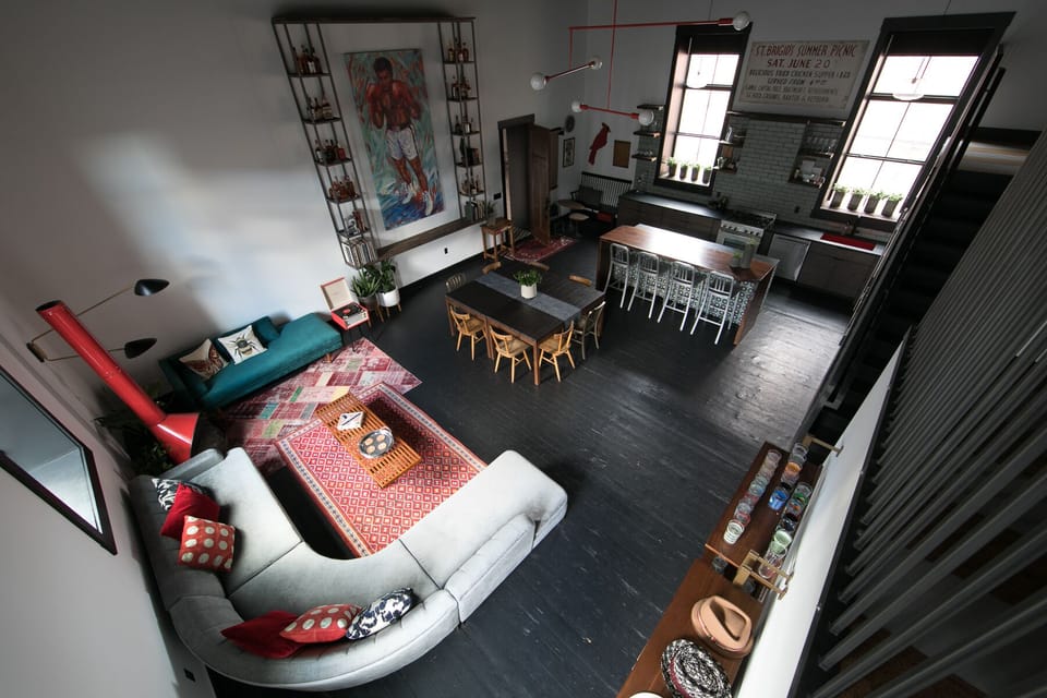 Shot of living, dining, and kitchen from mezzanine