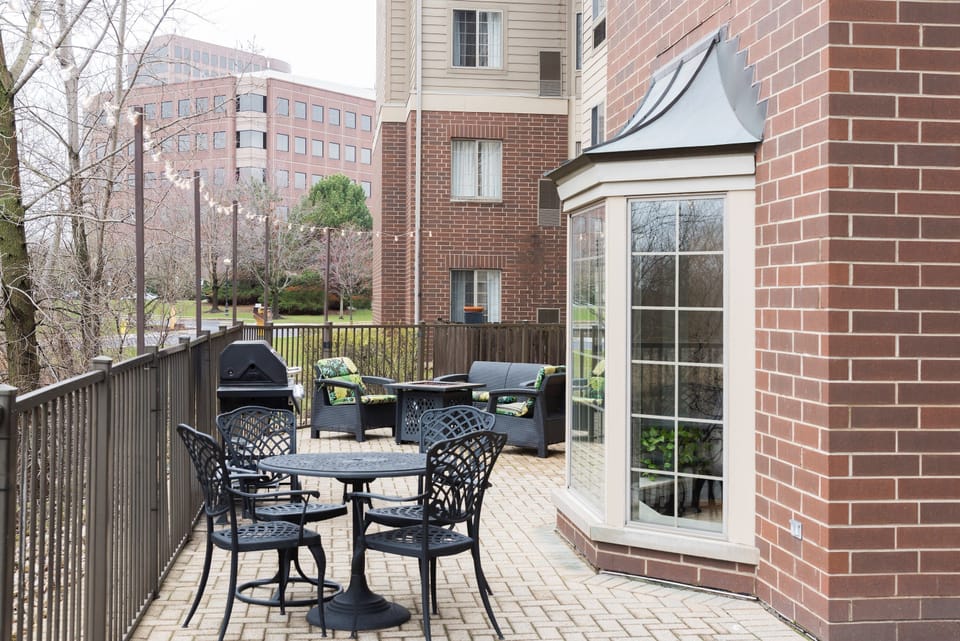 Patio deck with outdoor seating and gas grill.