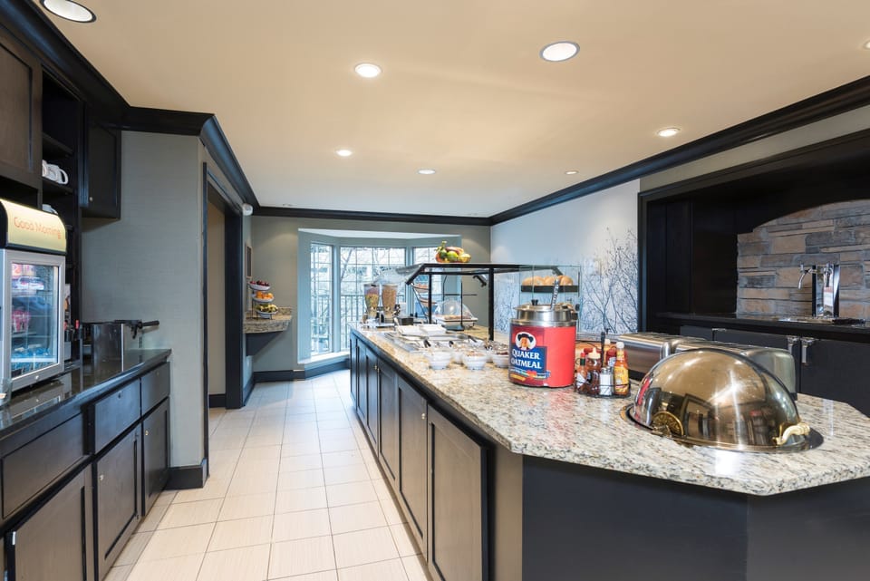 Breakfast station with hot food and coffee service.