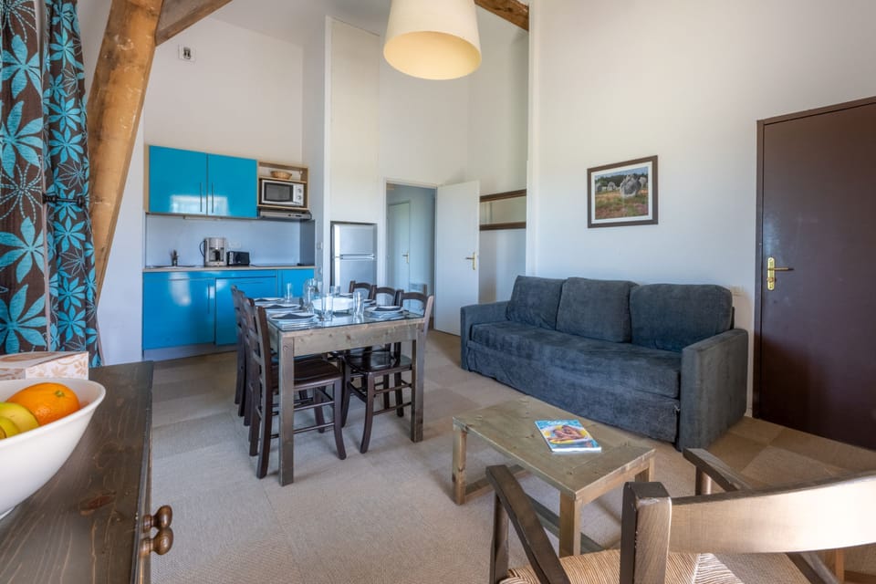Blue cabinetry brightens the kitchen, stocked for cooking up local Breton dishes.