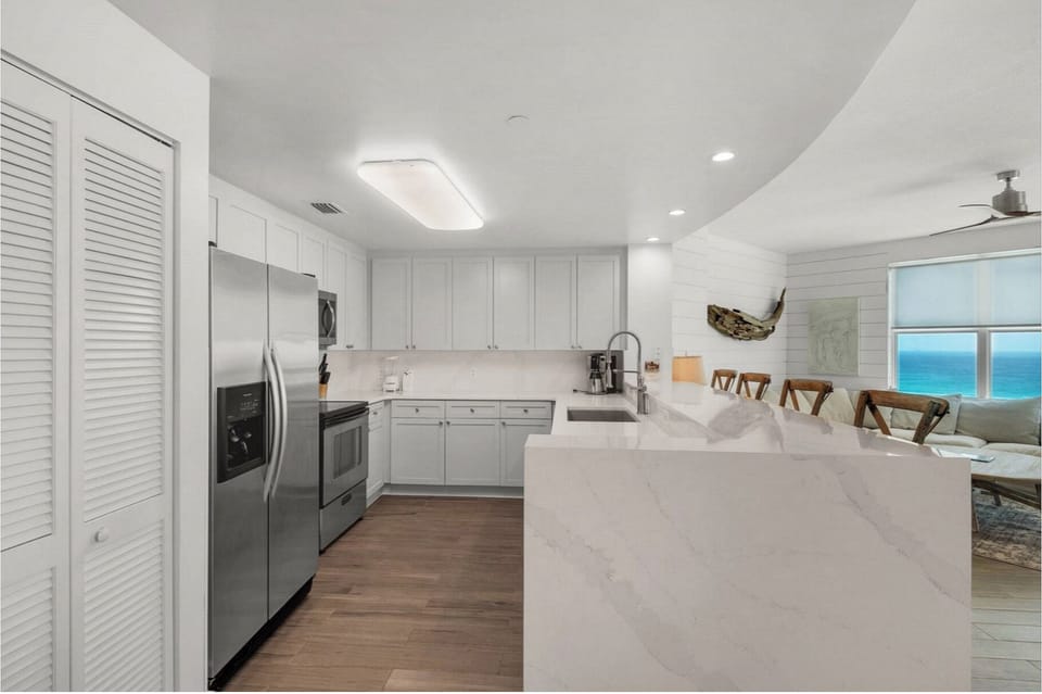 Your gourmet kitchen features marble countertops and ocean views, perfect for creating memorable meals during your stay.