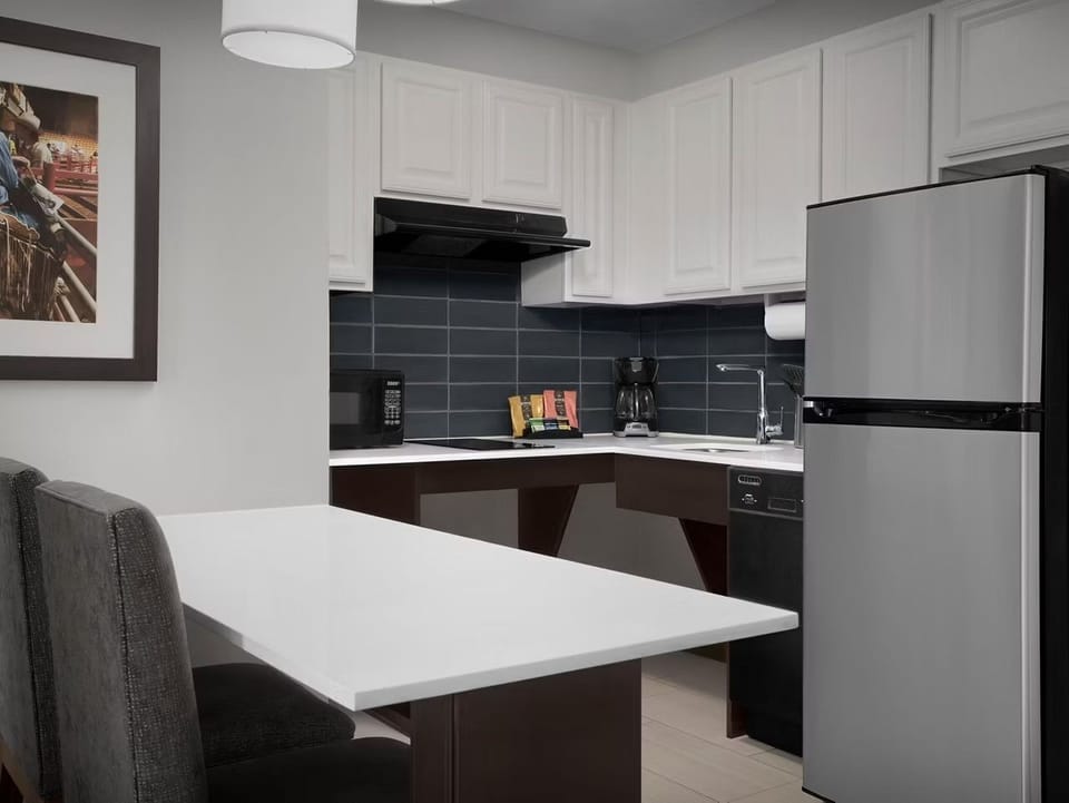Kitchen area with appliances and seating.