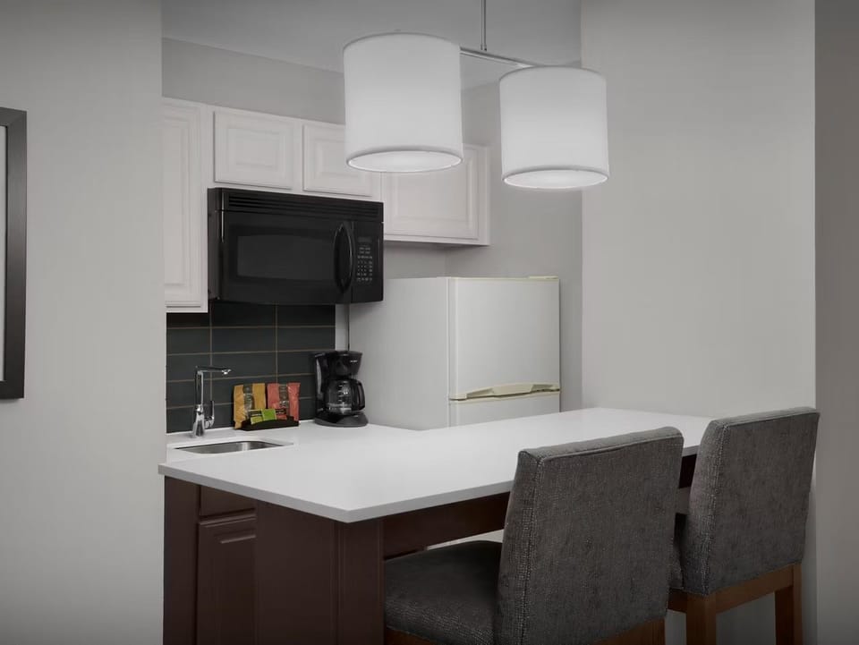 Kitchen with modern appliances and seating area.