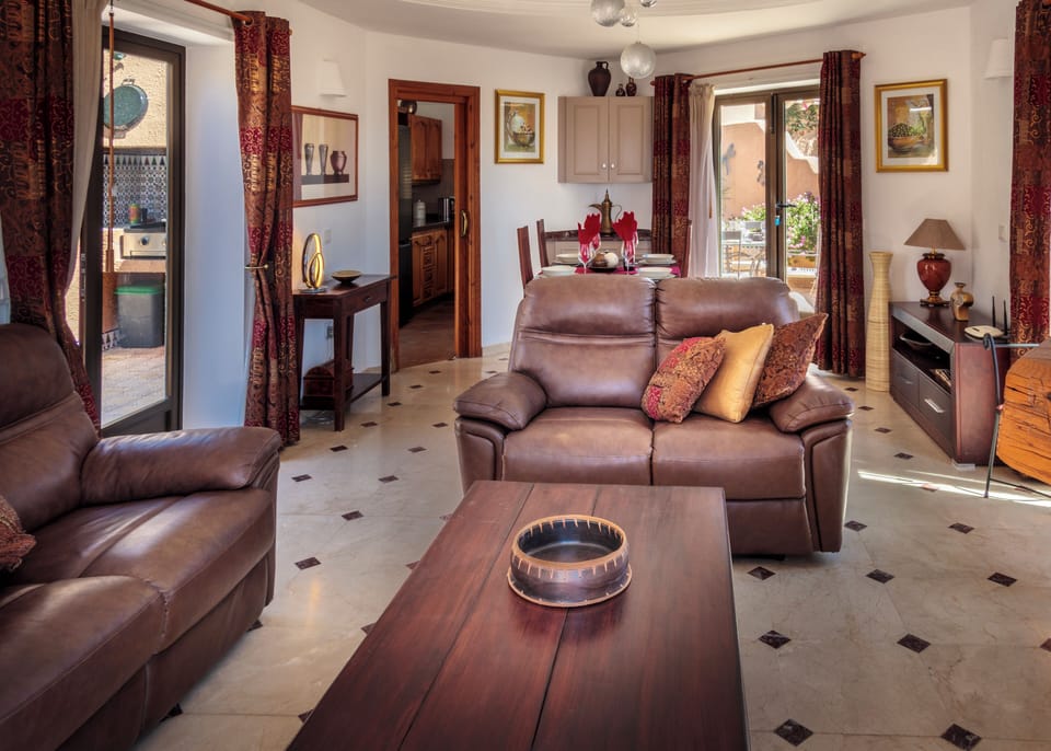 Well furnished bright and airy Lounge/Dining Room with patio doors to the patios