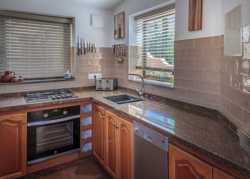 The kitchen includes oven/hob, dishwasher, fridge/freezer and coffee machine...