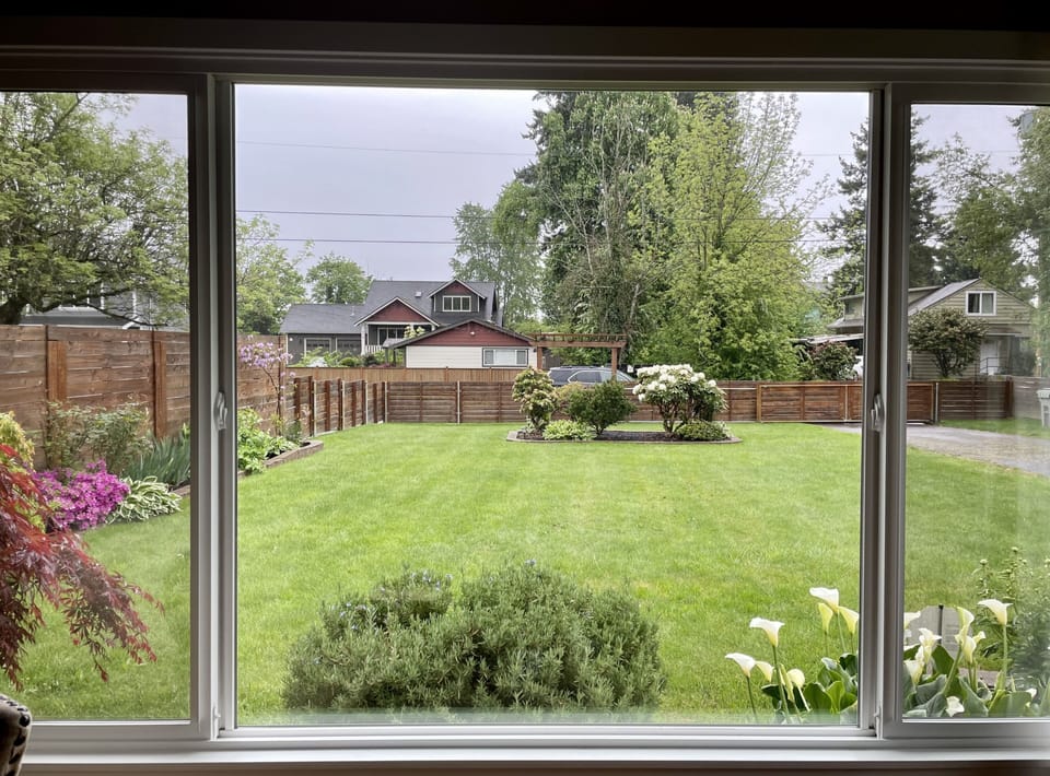 Living room window view over beautifully landscaped private & gated front yard. 