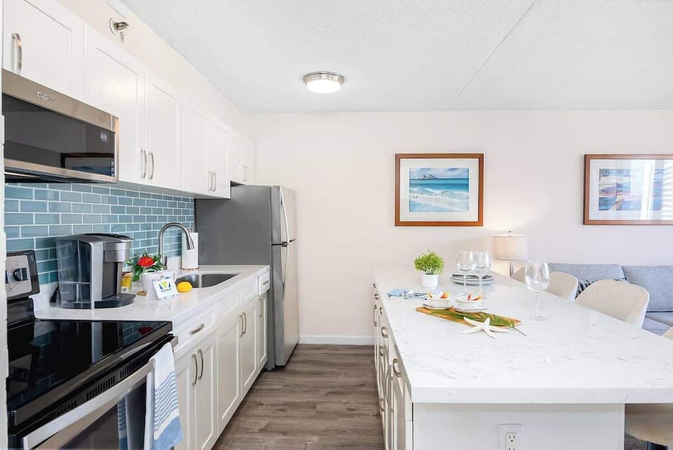 Modern kitchen with a large marble island and stainless steel appliances