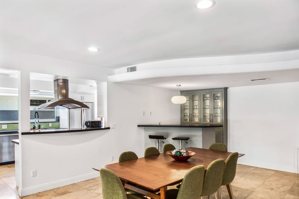 Inside dining room seats 8 and has a bar and ample glassware. 