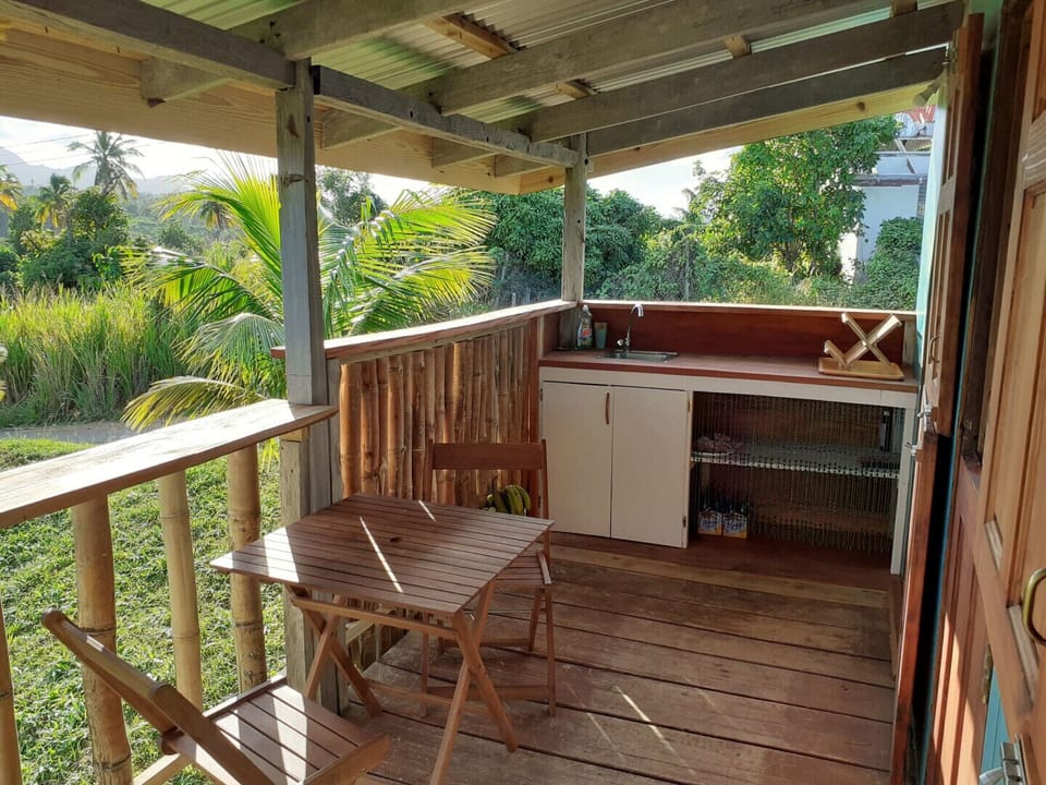 outdoor kitchen with dining area on verandah