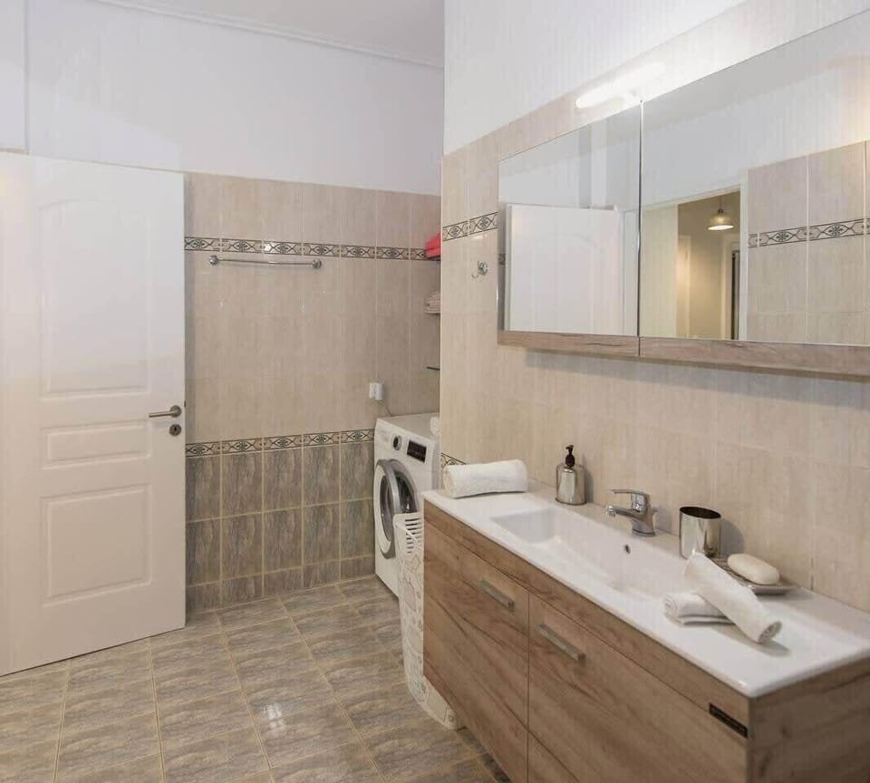 First Bathroom with Walk-In Shower – Contemporary style with easy access and neutral tones.