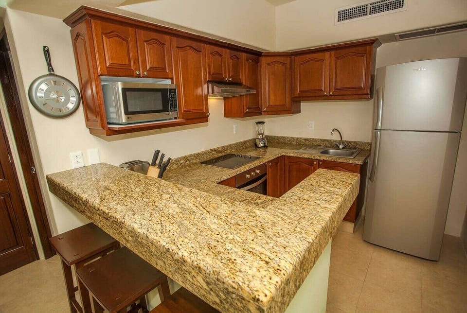 Kitchen with sit-up bar and marble counter tops