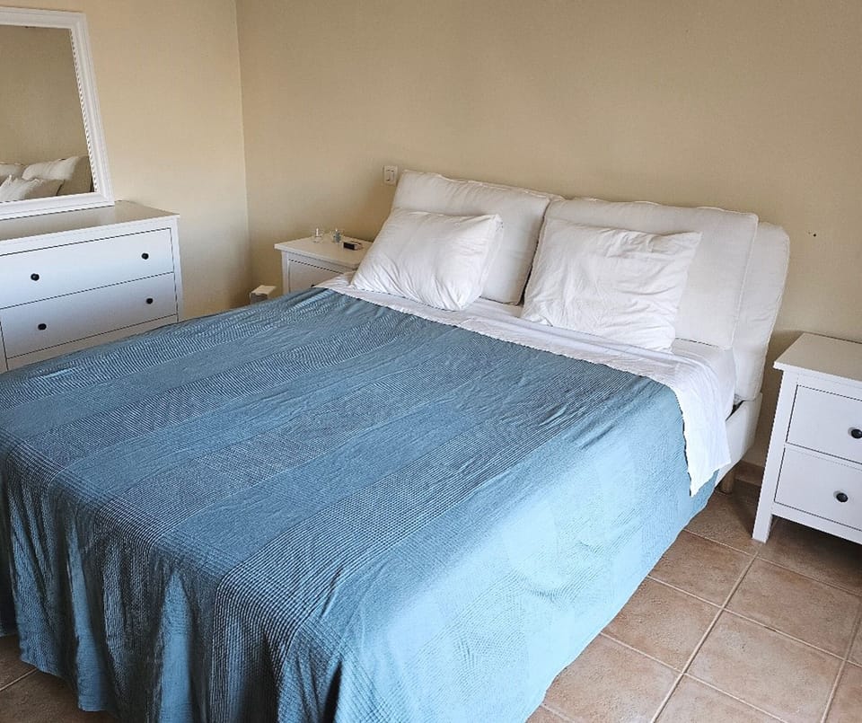 Downstairs Bedroom 1 has 5ft bed, ensuite bathroom and doors to the pool area