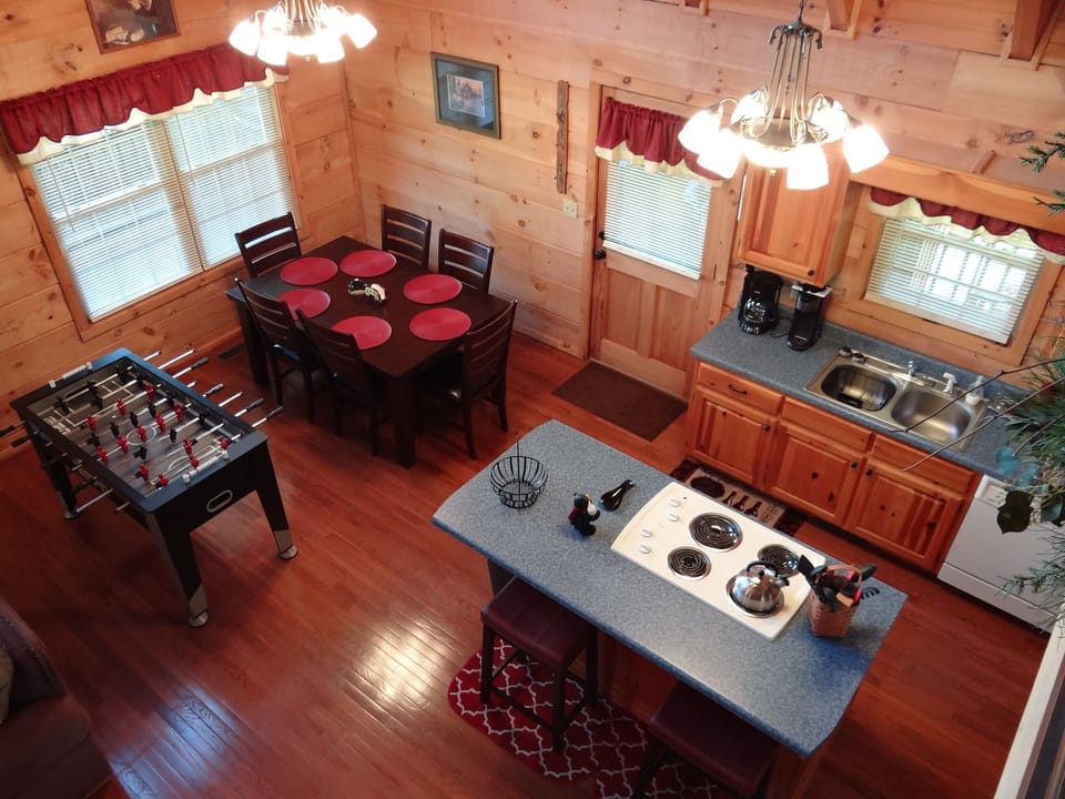 Viewing kitchen & dining table, including a Foosball table, from the loft area.