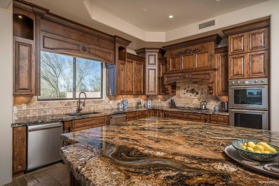 [Kitchen] Fully equipped with double ovens, gas cooktop, and large center island