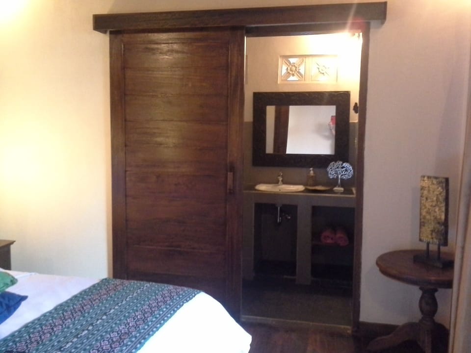 Wood barn door separates toilet from room.