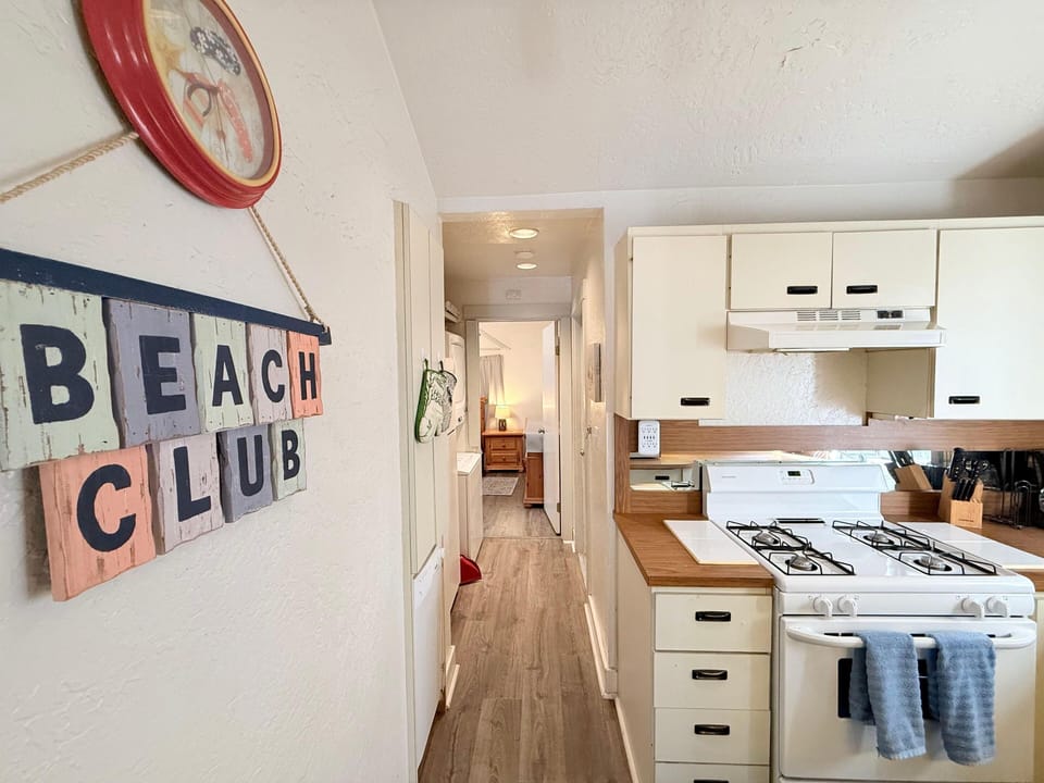 Cozy kitchen with charming beach-themed decor and warm wood accents