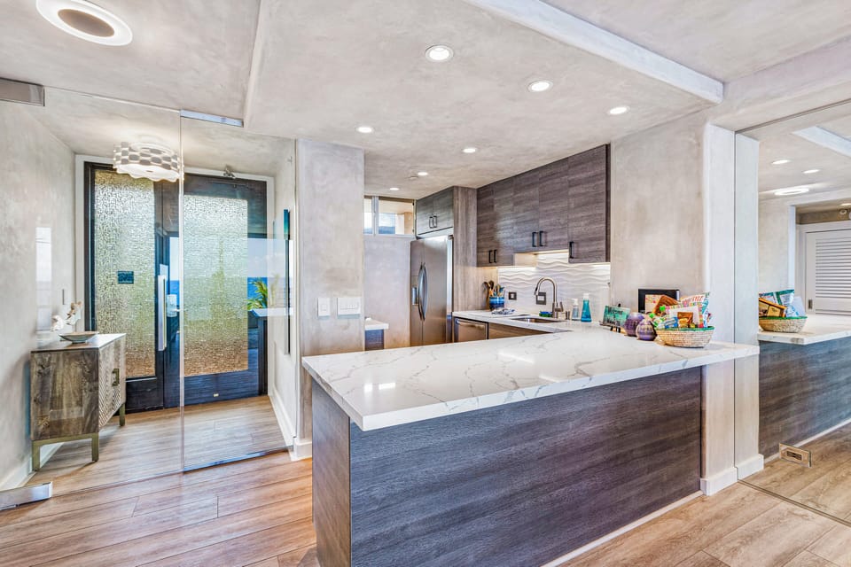 Entryway with custom glass door and top of the line kitchen.