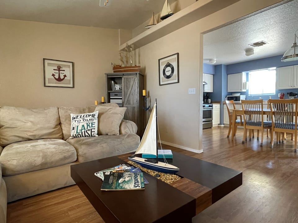 Inviting living room with plush couch, lake decor and open floor plan 