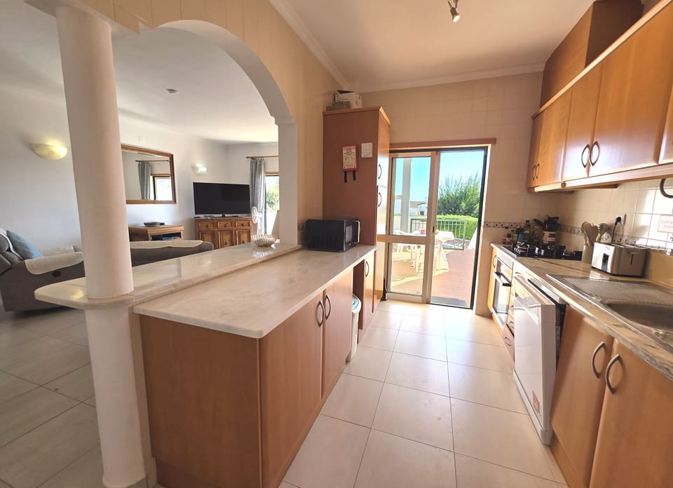 Well equipped kitchen and  the door leading to the veranda with table & chairs