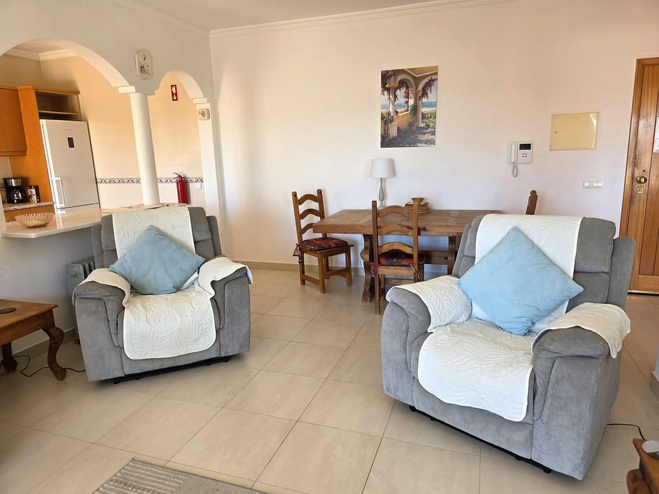 Living area with front door at back on the right