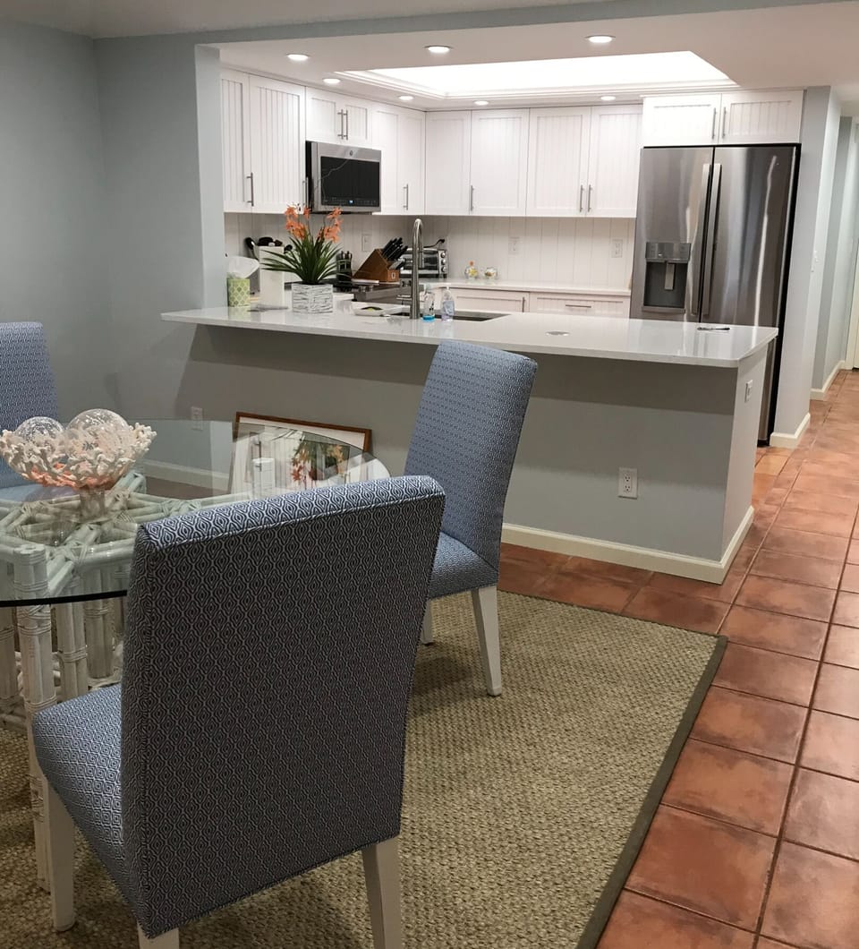 Kitchen has a wide-open view to dining room and living room.