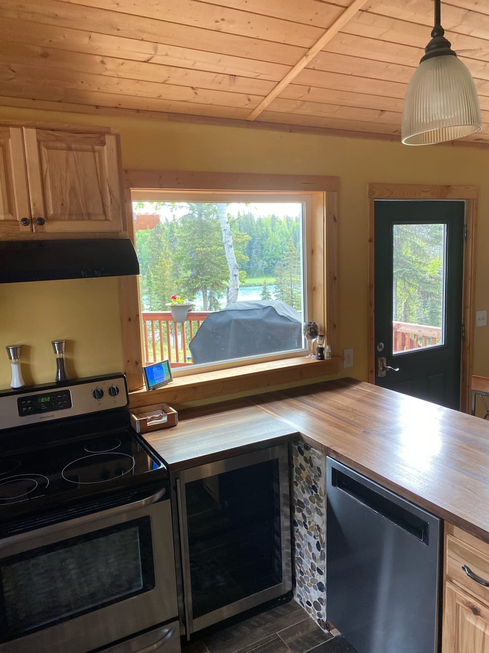 Dishwasher, small fridge,  river view from kitchen.