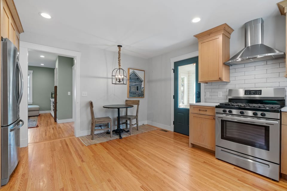 Your fully equipped kitchen invites culinary adventures with gleaming appliances, subway tile backsplash, and cozy breakfast nook for morning coffee.